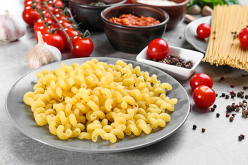 Plate with delicious pasta on table