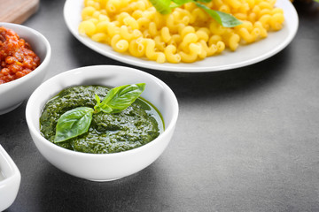 Bowl with delicious pesto sauce for pasta on table