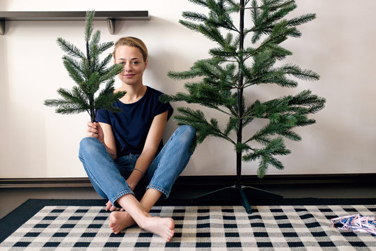 Woman Is Holding A Christmas Tree Twig