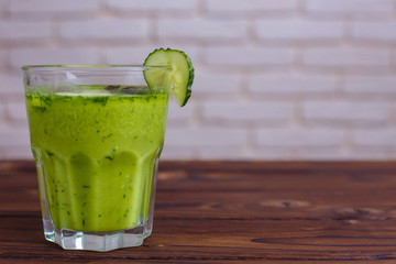 Diet concept, healthy lifestyle, low calorie detox and dietary food. Blended green smoothie on wooden table, copy space