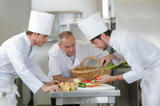 chef supervising trainees cooking