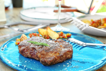Delicious steak on blue plate