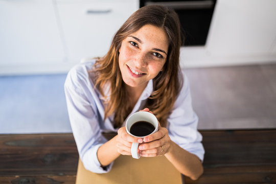 Woman having a coffee at home