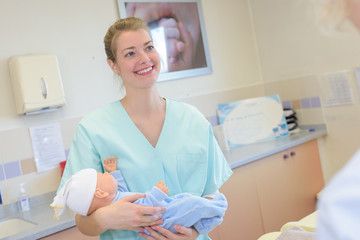 Obraz na płótnie Canvas nurse holding new born at maternity