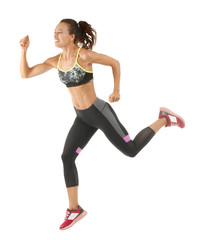 Beautiful young woman in sportswear running on white background