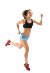 Beautiful young woman in sportswear running on white background
