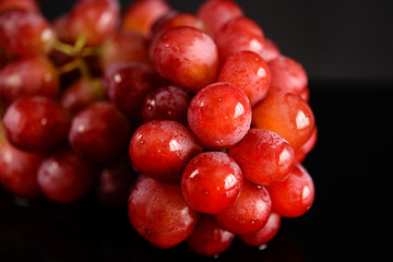 Bunch of red grapes. Black background