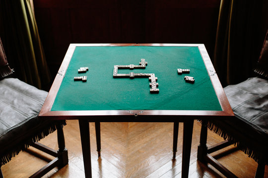 Dominoes strategy game on felt table