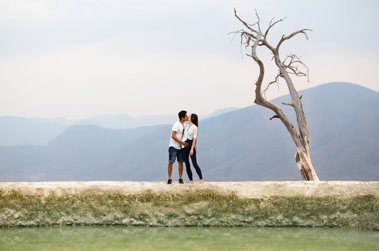 Young couple kissing at the edge of Petrified waterfall