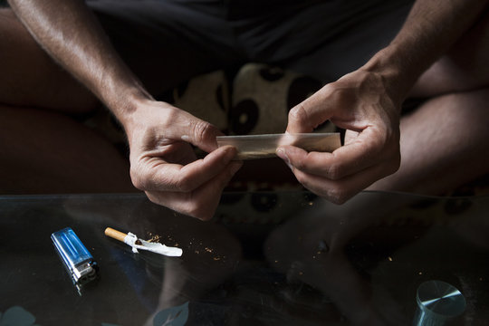 Close up of Hands of a man making a joint.