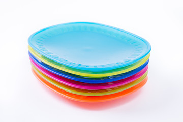 Colorful plastic plates closeup isolated on white background
