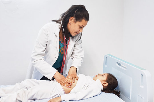 Doctor examines little girl's abdomen