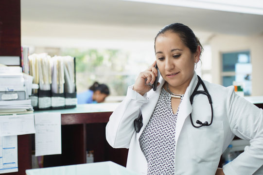 Female Doctor Talking On Phone In The Hospital