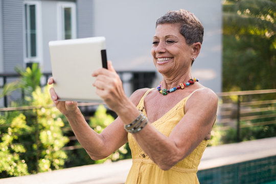 Woman Taking a Selfie With a Tablet Computer