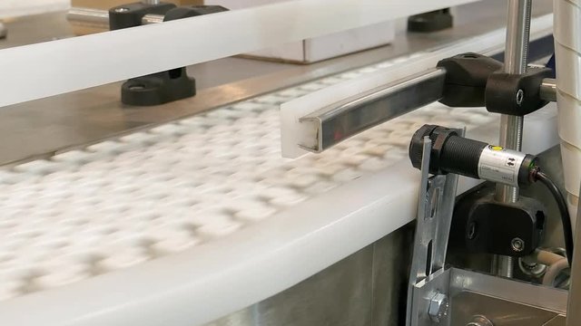 Food factory automated robotic machine. Conveyor product line for cooking and packing rations and food packs. Robotics and automatic lines used instead of human labor on factories and plants.