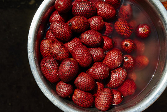 Close-up of red fruits in bowl of water