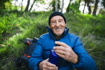 Portrait of a senior mountaineer resting in the nature.