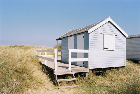 Beach huts among the sand dunes at Old Hunstanton, Norfolk, UK.