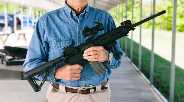 Shooting: Senior Male Holding AR-15 Gun On Rifle Range