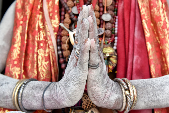 Detail of a sadhu's hands praying on a temple