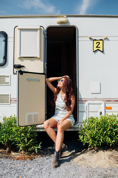 Woman sitting in trailer enjoying sunshine