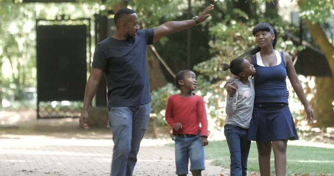  Happy African American family taking a walk & having fun outdoors in summer