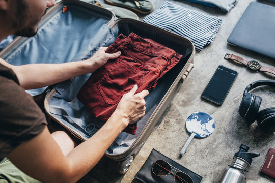 Man Packs His Suitcase