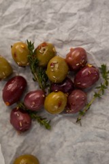 Olives with thyme on wax paper
