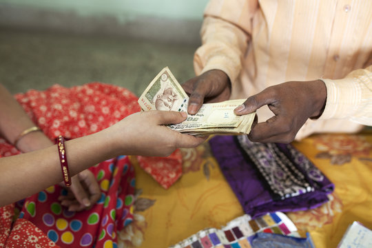 Small businessman accepting money from customer