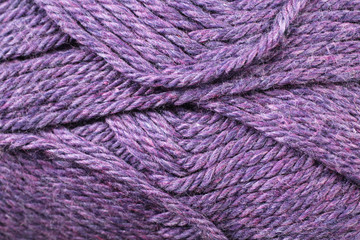 A super close up image of royal purple yarn