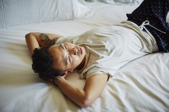 Thoughtful Mid Adult Man Lying In Bed