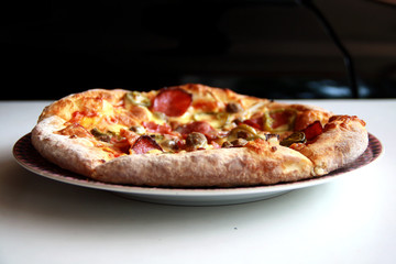 Pizza with topping Smoked Beef, Onion, Green Pepper, and Mozzarella Cheese.