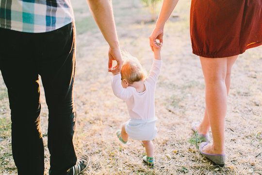 Little baby boy toddle with his parents
