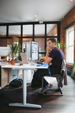 Young caucasian man working at the computer in office setting