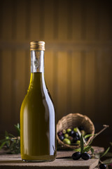 Olive oil and olives on wooden rustic table