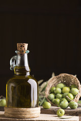 Olive oil and olives on wooden rustic table