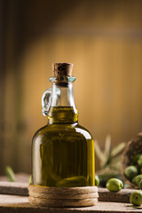 Olive oil and olives on wooden rustic table