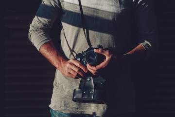 Tredny young man with camera in his hands