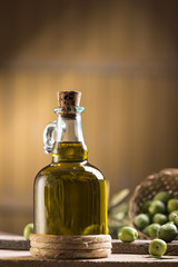 Olive oil and olives on wooden rustic table