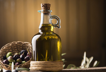 Olive oil and olives on wooden rustic table