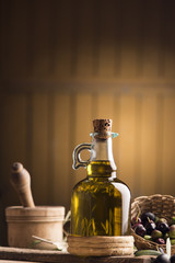 Fototapeta na wymiar Olive oil and olives on wooden rustic table