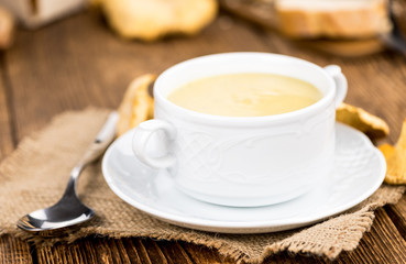 Chanterelle Soup on wooden background; selective focus