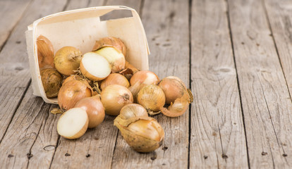 Portion of White Onions on wooden background, selective focus
