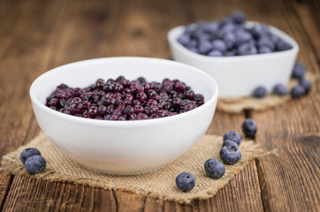 Portion of Blueberries (preserved) on wooden background, selective focus