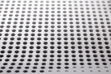 Abstract light colored surface with holes built in a row for creativity, wallpapers and backgrounds.