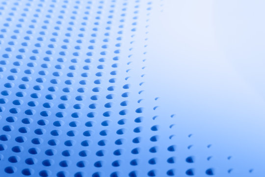 Abstract light colored surface with holes built in a row for creativity, wallpapers and backgrounds.