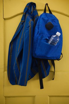 School Uniform And Bag Hanging On Door