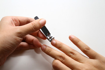 cutting nails / A nail clipper is a hand tool used to trim fingernails, toenails and hangnails