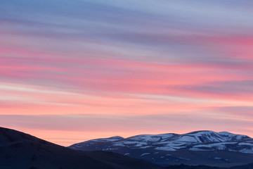 amazing view of plain at root of mountains at fairy pink sunset 
