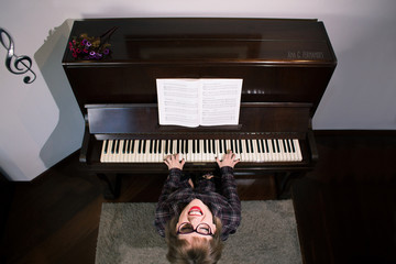 blonde young woman playing the piano